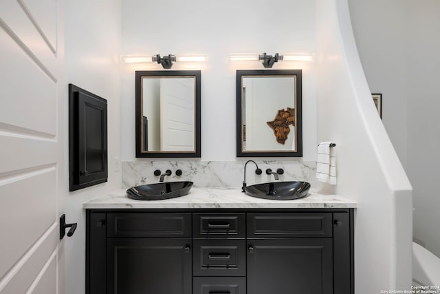 bathroom with vanity and backsplash