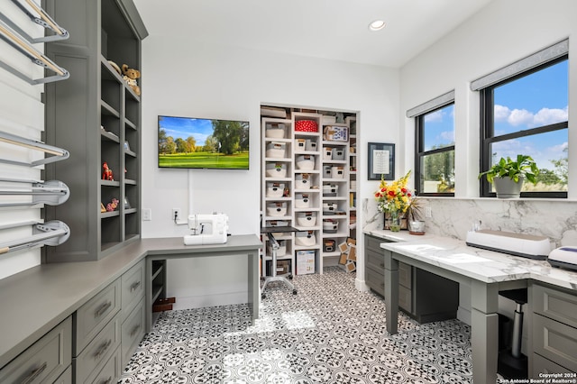 office featuring built in desk and light tile patterned flooring