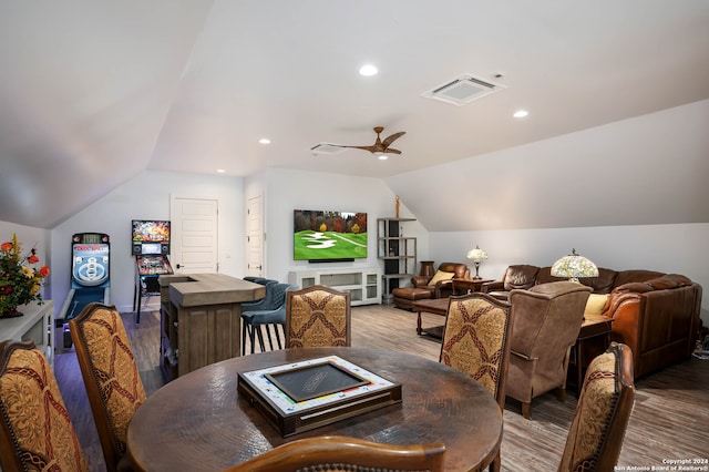 dining room with hardwood / wood-style floors, ceiling fan, and vaulted ceiling