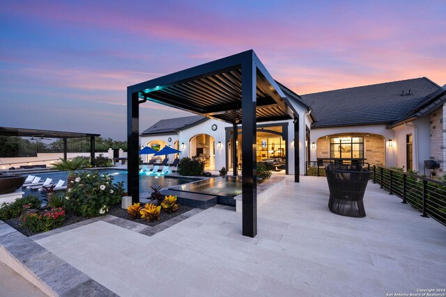 view of patio terrace at dusk