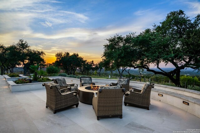 patio terrace at dusk with an outdoor fire pit