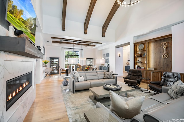 living room with light hardwood / wood-style flooring and a premium fireplace