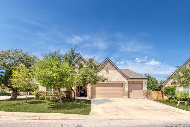 view of front of home featuring a front yard and a garage