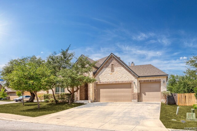 view of front of home featuring a front lawn and a garage