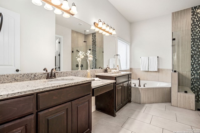 bathroom with tile patterned flooring, shower with separate bathtub, and vanity