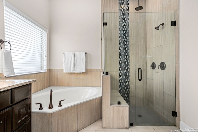 bathroom with tile patterned flooring, vanity, and separate shower and tub