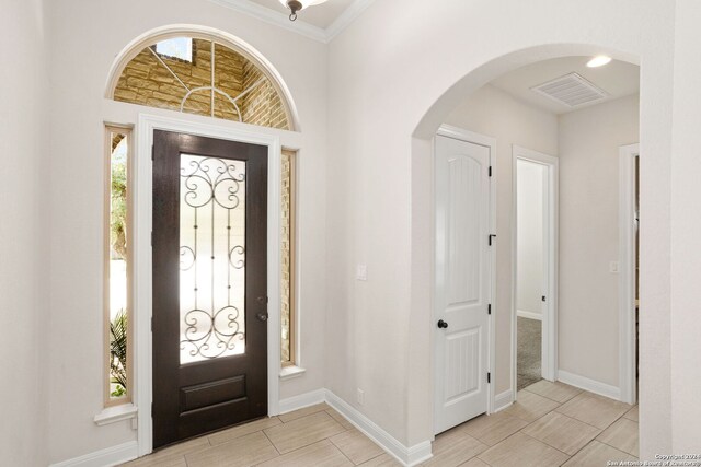 entryway featuring ornamental molding