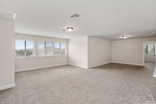 carpeted empty room featuring plenty of natural light