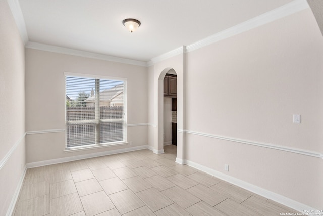 spare room featuring crown molding