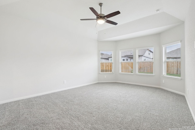 empty room with carpet flooring, ceiling fan, and vaulted ceiling