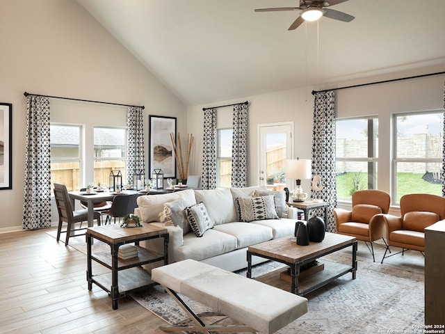 living room with ceiling fan, light wood-type flooring, and high vaulted ceiling