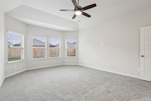 carpeted empty room with ceiling fan and lofted ceiling