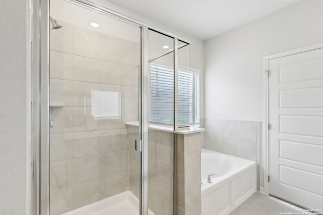 bathroom with tile patterned floors and independent shower and bath