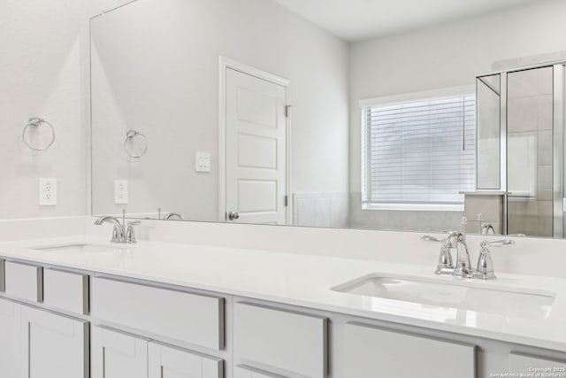 bathroom with a shower with door and vanity