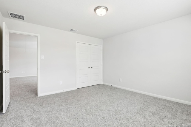 unfurnished bedroom featuring a closet and carpet