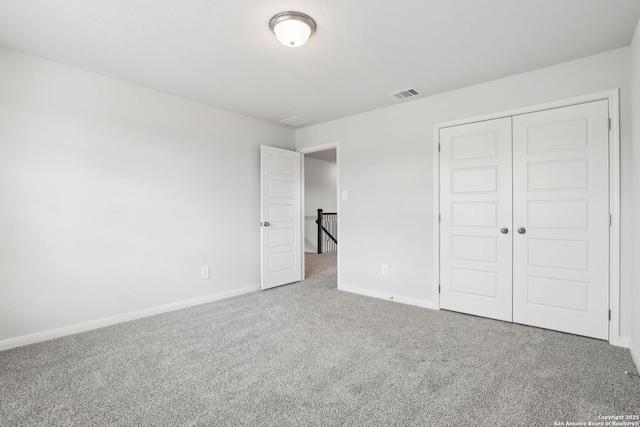 unfurnished bedroom with a closet and carpet flooring