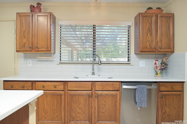 kitchen with dishwasher, sink, and backsplash