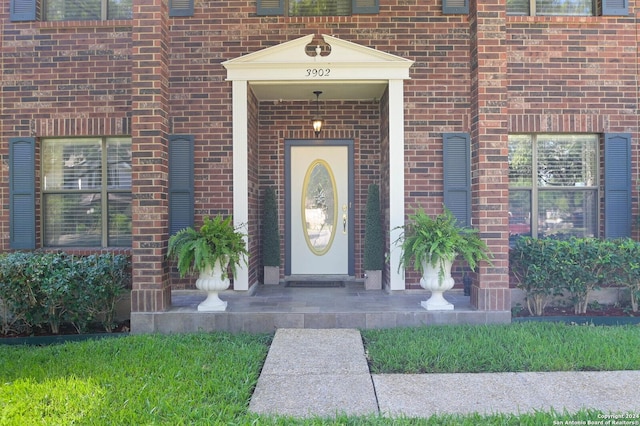 property entrance featuring brick siding