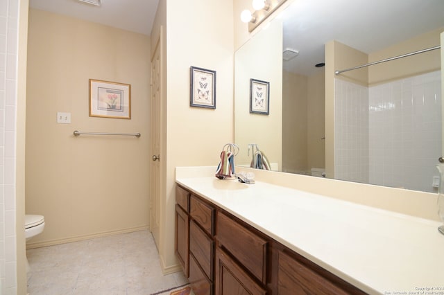 bathroom featuring tile patterned flooring, walk in shower, toilet, and vanity