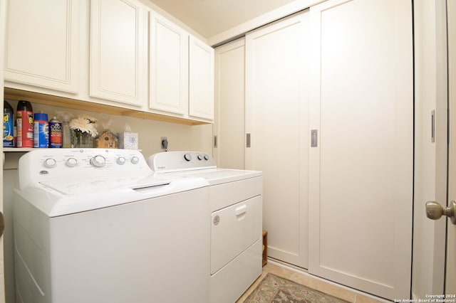 washroom with cabinets and washer and clothes dryer