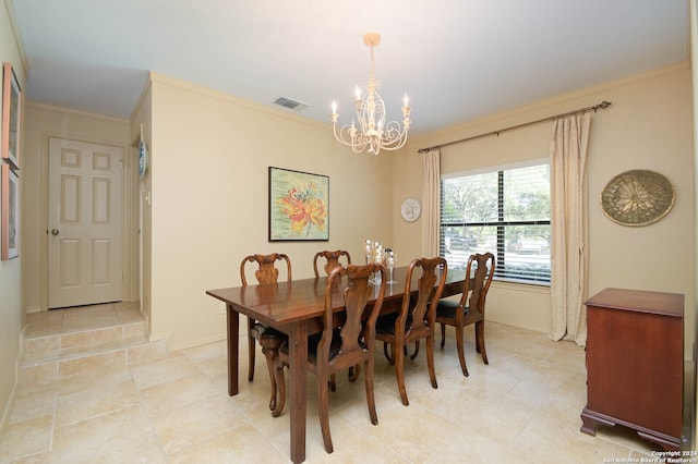 dining room with ornamental molding, light tile patterned floors, and a chandelier