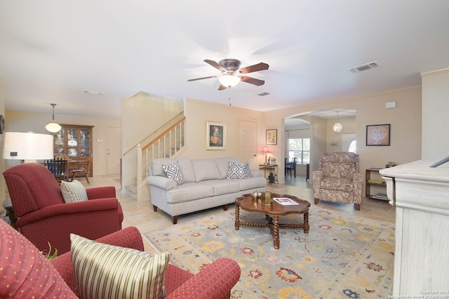 tiled living room with ceiling fan