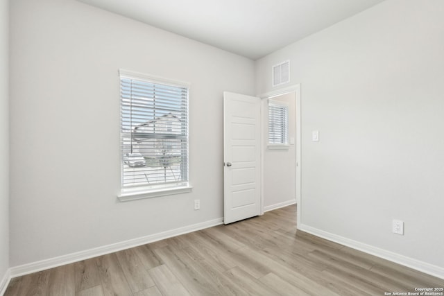 unfurnished room featuring light hardwood / wood-style flooring