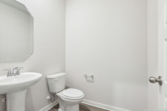 bathroom featuring toilet and sink