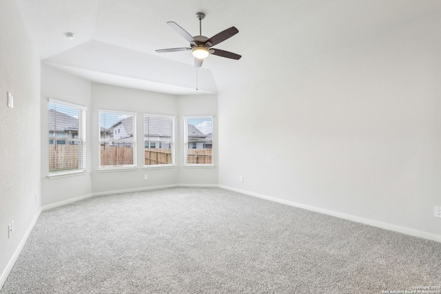 unfurnished room featuring lofted ceiling, ceiling fan, and carpet