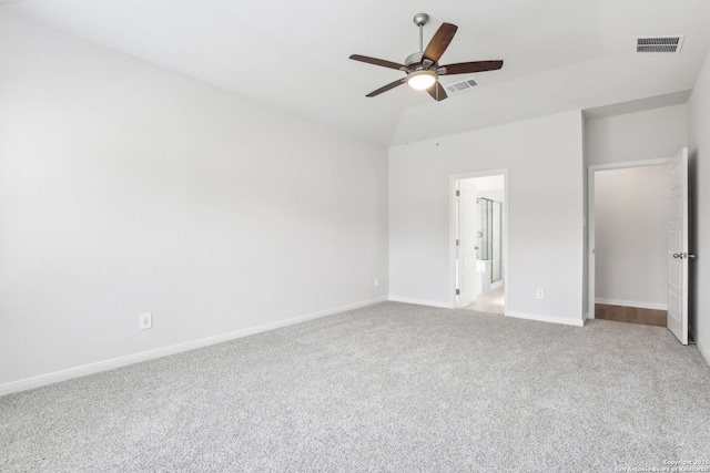 unfurnished bedroom featuring vaulted ceiling, carpet floors, ceiling fan, and connected bathroom