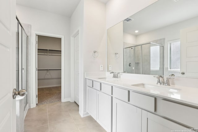 bathroom featuring an enclosed shower, tile patterned floors, and vanity