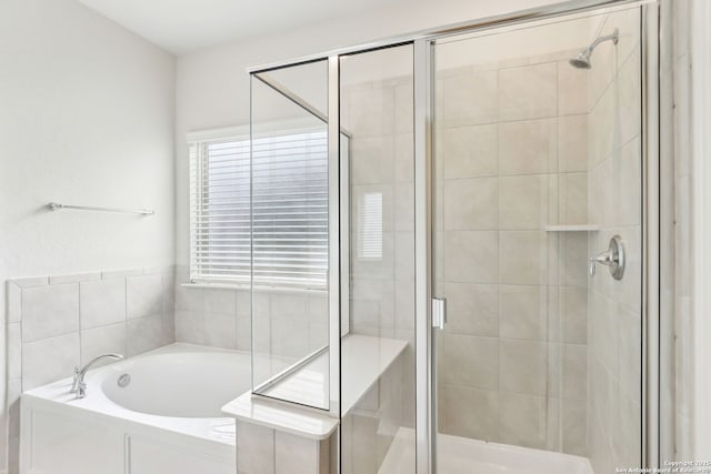 bathroom with shower with separate bathtub