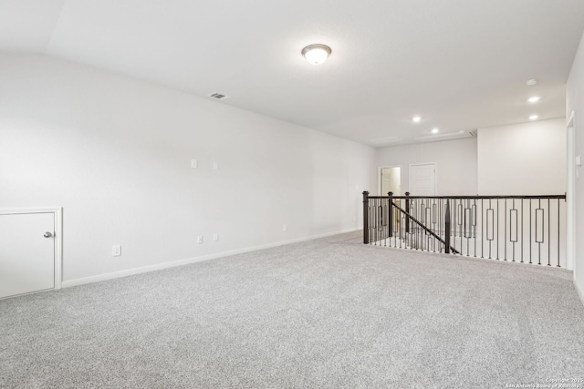 empty room with lofted ceiling and carpet flooring