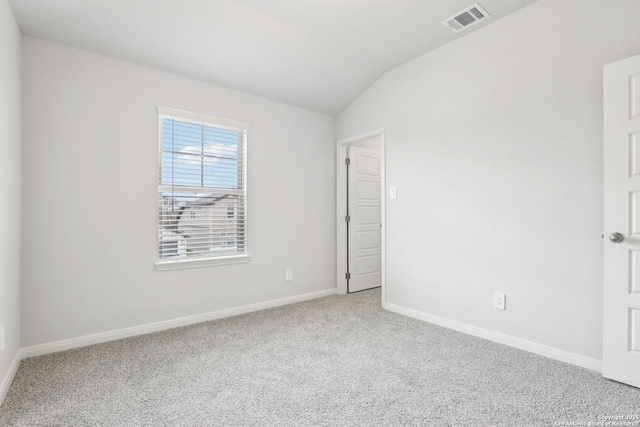 spare room with lofted ceiling and carpet floors