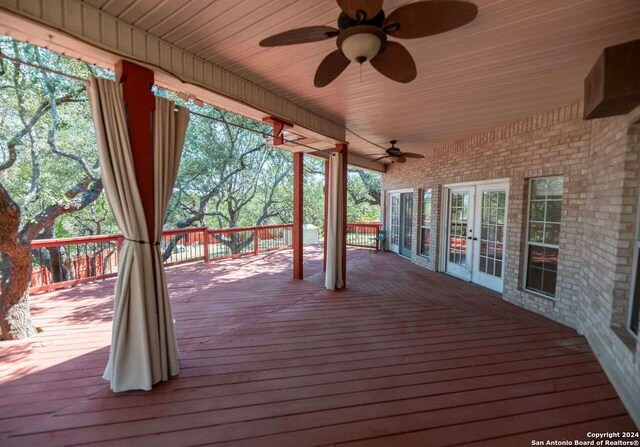 wooden deck featuring ceiling fan