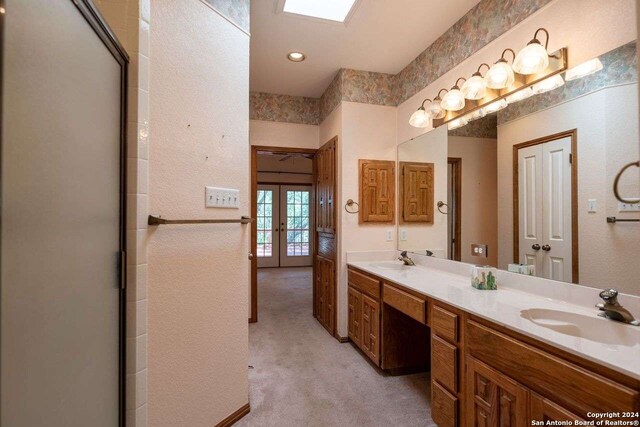 bathroom with french doors and vanity