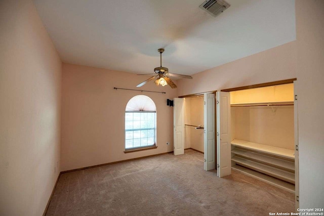 unfurnished bedroom with light colored carpet and ceiling fan