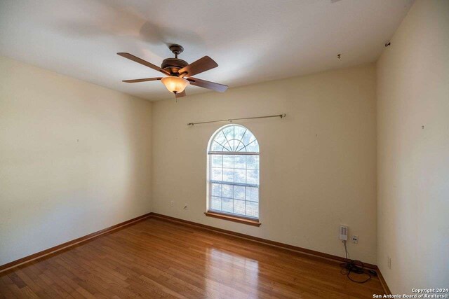 spare room featuring ceiling fan and hardwood / wood-style flooring