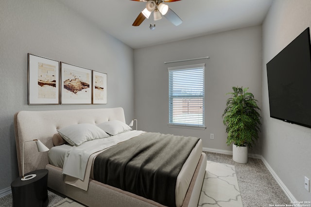 bedroom with ceiling fan and light carpet