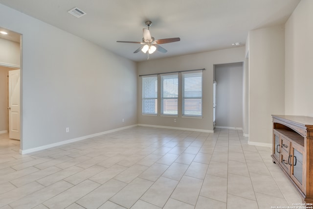 empty room featuring light tile patterned flooring and ceiling fan