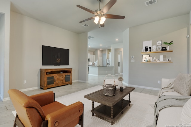 tiled living room with ceiling fan