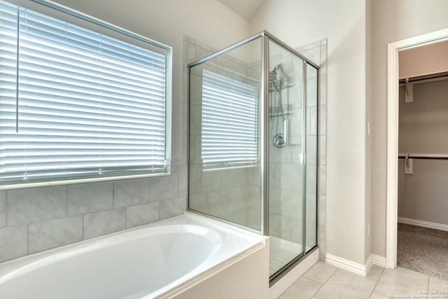 bathroom featuring separate shower and tub, plenty of natural light, and tile patterned flooring