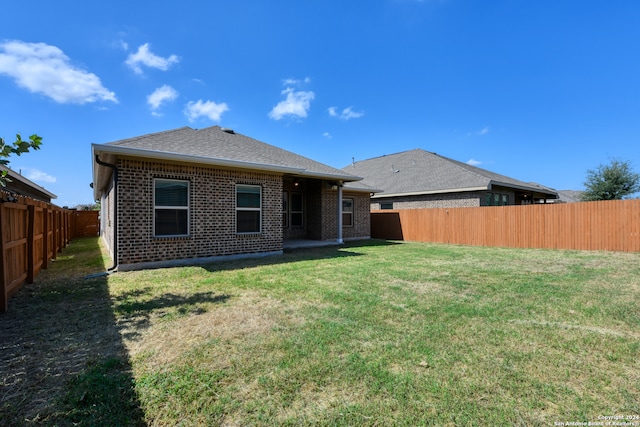 back of property featuring a yard and a patio area