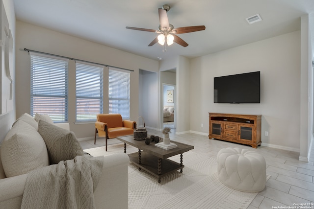 living room with ceiling fan and light tile patterned flooring