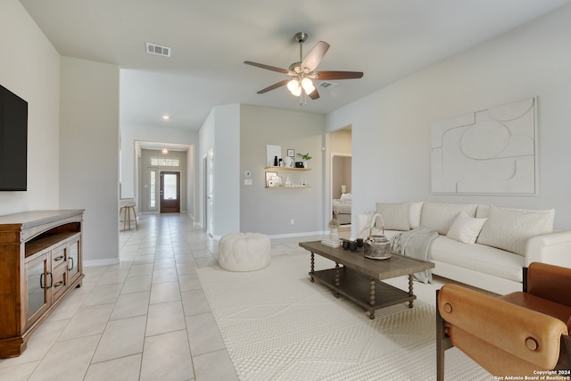 tiled living room featuring ceiling fan