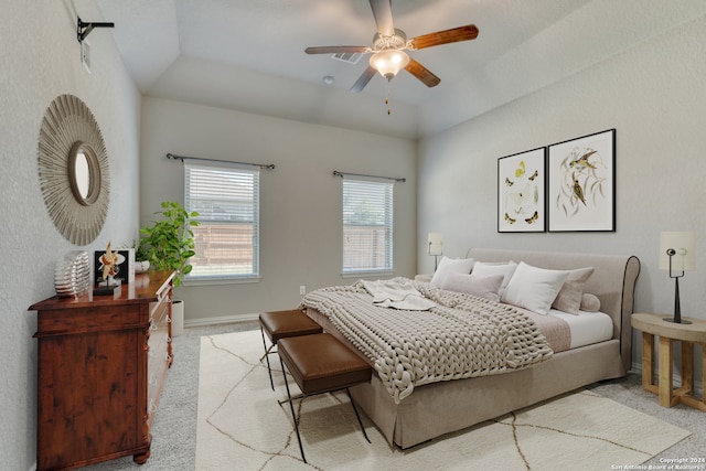 bedroom featuring light carpet, vaulted ceiling, and ceiling fan