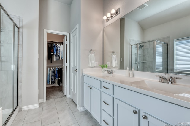 bathroom featuring walk in shower, vanity, vaulted ceiling, and tile patterned floors