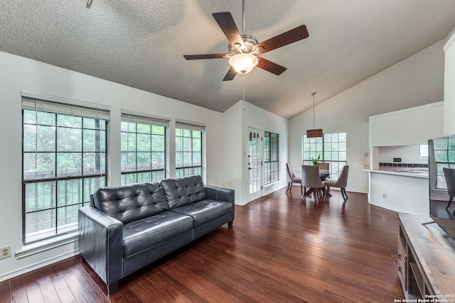 living room with a textured ceiling, dark hardwood / wood-style flooring, french doors, high vaulted ceiling, and ceiling fan