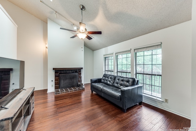 living room with high vaulted ceiling, ceiling fan, dark hardwood / wood-style floors, and a textured ceiling