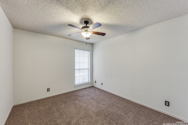 spare room featuring a textured ceiling, carpet, and ceiling fan